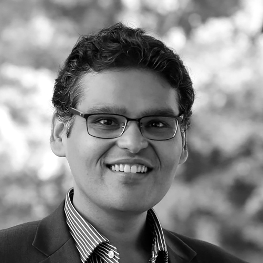 black and white photo of nishant shah smiling at camera showing shoulders and head