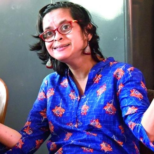 Photo of Jeeja Ghosh wearing a blue shirt and red glasses