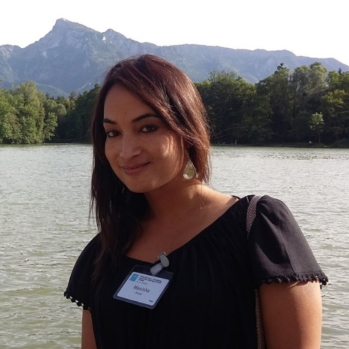 photo of manisha dhakal in front of a lake and mountains